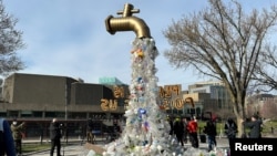 A prop depicting a water tap with cascading plastic bottles is displayed by activists near the Shaw Centre venue of penultimate negotiations for the first-ever global plastics treaty, in Ottawa, Ontario, Canada, April 23, 2024. 
