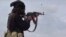FILE - This frame from video posted online March 18, 2019, by the Aamaq News Agency, a media arm of Islamic State, shows an IS fighter during clashes in Baghouz, Syria. IS gunmen ambushed a bus carrying Syrian soldiers on Aug. 10, 2023, killing at least 20 and wounding others.