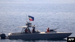 FILE - A boat of Iran's Islamic Revolutionary Guard Corps Navy operates in the Strait of Hormuz, June 20, 2022. The Revolutionary Guards' Navy reportedly intercepted a UAE-managed tanker engaged in fuel smuggling on July 21, 2024. (Photo by DVIDS / AFP)