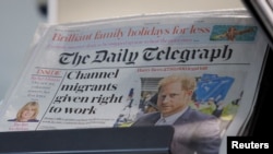 FILE - Copies of The Daily Telegraph are displayed on a rack in a London supermarket, Jan. 20, 2024. 