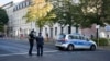 FILE - German police officers stand guard in front of the building complex of the Kahal Adass Jisroel community, which houses a synagogue, a kindergarten and a community center, in the center of Berlin, Germany, Oct. 18, 2023.