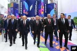 From left, the presidents of Kazakhstan, Russia, Uzbekistan, Tajikistan and Kyrgyzstan arrive for the opening ceremony of the Games of the Future, at the Kazan Expo center outside Kazan, Tatarstan, Russia, Feb. 21, 2024. (Kremlin Pool Photo via AP)