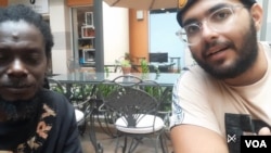 FILE - YouTube influencer Addison Pierre (right) and fixer Ayisyen Jean Sacra Sean Roubens, during an interview with VOA Creole Service, March 30, 2024. 