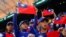 FILE - Baseball players hold the Taiwanese flag while waiting for the match between Taiwan and Panama in the 2023 World Baseball Classic game in Taichung, Taiwan March 8, 2023. 