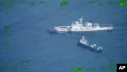 In this image released by the Armed Forces of the Philippines, a Philippines supply boat, top left, sails near a Chinese coast guard ship, top right, and a Chinese militia vessel in the disputed South China Sea, Oct. 22, 2023.