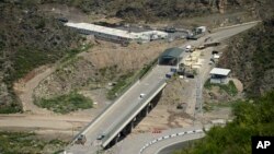 FILE - A bridge and a checkpoint are seen on a road towards the separatist region of Nagorno-Karabakh in Armenia, July 28, 2023. 