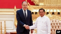 FILE - In this handout photo released by Russian Foreign Ministry Press Service, Myanmar State Administration Council Chairman Senior General Min Aung Hlaing, right, and Russian Foreign Minister Sergey Lavrov pose during their meeting in Naypyitaw, Myanmar, Aug. 3, 2022.