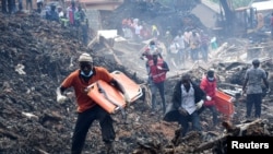 Volunteers arrive to search for the bodies of residents killed by a landslide due to heavy rainfall in a landfill known as Kiteezi that serves as garbage dumping site, in the Lusanja village, outside Kampala, Uganda, Aug. 10, 2024.