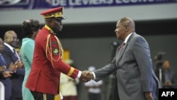 FILE - Gabon Transitional President General Brice Oligui Nguema, left, shakes hands with the President of the Central African Republic Faustin-Archange Touadera at the opening of the National Dialogue in Gabon in Libreville, April 2, 2024. 
