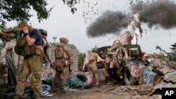 FILE - In this photo released by the Russian Defense Ministry Press Service on June 25, 2024, Russian soldiers fire the 152-mm howitzer "Msta-B" in an undisclosed location in Ukraine. (Russian Defense Ministry Press Service via AP)