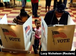 Women vote in the U.S. presidential election in Los Angeles on Nov. 4, 2008.