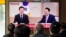 People watch a TV screen showing South Korean President Yoon Suk Yeol, right, meeting with main opposition Democratic Party leader Lee Jae-myung, during a news program at the Seoul Railway Station in Seoul, April 29, 2024. 