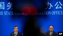 Shen Hongbing, director of the Chinese Center for Disease Control and Prevention, (L) and Tong Yigang, dean of the College of Life Science and Technology in Beijing, April 8, 2023.