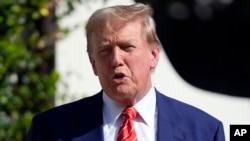 FILE - Republican presidential candidate and former President Donald Trump speaks after voting in Florida's primary election in Palm Beach, Florida, March 19, 2024. 