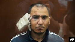 Saidakrami Murodali Rachabalizoda, a suspect in the Crocus City Hall shooting, sits in a glass cage in the Basmanny District Court in Moscow, Russia, March 24, 2024.