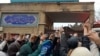 This grab taken from a UGC video made available on the ESN platform on March 4, 2023, shows families gathering and chanting slogans outside an education ministry building in Tehran, following poisoning attacks on students.