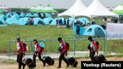 Participants for the 25th World Scout Jamboree arrive at a camping site in Buan, South Korea, Aug. 1, 2023. (Yonhap via Reuters)