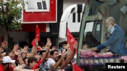 Turkish President Tayyip Erdogan gives presents to supporters during a rally, ahead of the May 28 presidential runoff vote, in Istanbul, Turkey, May 26, 2023.