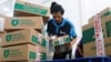 FILE - An employee prepares packages for shipping at a warehouse of e-commerce giant Tokopedia in Jakarta, Indonesia, Aug. 31, 2022. 