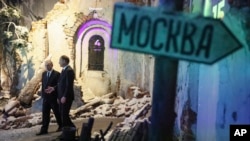 Russian President Vladimir Putin, left, accompanied by Victory Museum Director Alexander Shkolnik, visits the Victory Museum in Moscow, Russia, June 22, 2023.