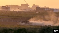 This picture taken from a position in southern Israel near the border with the Gaza Strip shows an Israeli armored vehicle rolling along the border on March 3, 2024.