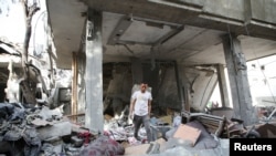 A Palestinian man inspects the site of an Israeli strike on a house, amid the ongoing conflict between Israel and the Palestinian Islamist group Hamas, in Rafah, in the southern Gaza Strip, April 25, 2024.