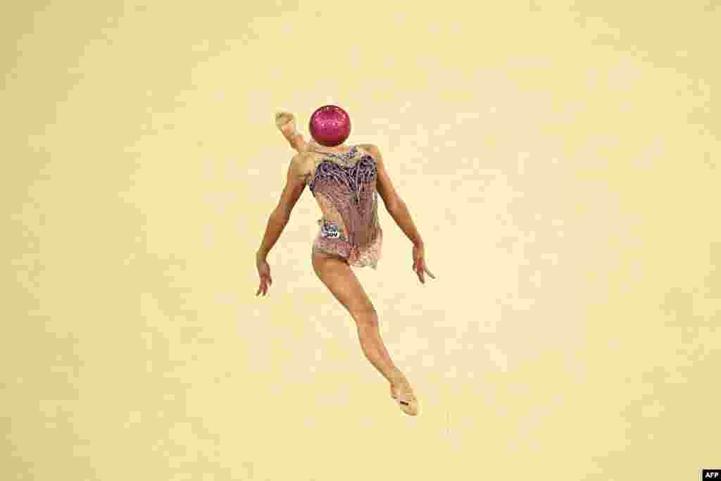 Italy's Sofia Raffaeli performs with the ball in the rhythmic gymnastics' individual all-around qualification during the Paris 2024 Olympic Games at the Porte de la Chapelle Arena in Paris.