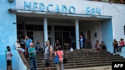 FILE - People queue to buy food in Havana, on March 8, 2024.