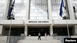 FILE - People walk outside Greece's Supreme Court in Athens, Sept. 17, 2012. The court assembly voted nine to one to disqualify Ilias Kasidiaris and his party, called The Greeks, from the May 21 polls.