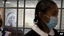 FILE - Students at Mother Mary Lange Catholic School walk past the chapel, which is decorated with a portrait of Mother Mary Lange, the foundress of the order of the Oblate Sisters of Providence, in Baltimore, Maryland, April 27, 2022. 