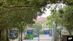 Buildings in the Shanghai Public Health Clinical Center stand near the entrance of the compound in Shanghai, April 30, 2024. Scientist Zhang Yongzhen staged a sit-in protest after authorities locked him out of his lab at the center.