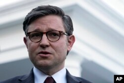 U.S. House Speaker Mike Johnson talks with reporters outside the White House in Washington, Jan. 17, 2024, after meeting with President Joe Biden.