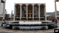 FILE - The Metropolitan Opera house, background center, appears at Lincoln Center in New York on March 12, 2020.