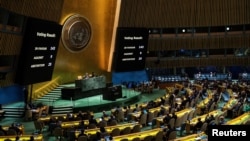 Screens show the voting result during the United Nations General Assembly vote on a draft resolution that would recognize the Palestinians as qualified to become a full U.N. member, in New York, May 10, 2024. 