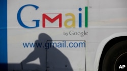 FILE - An ad for Google's Gmail appears on the side of a bus in Lagos, Nigeria, Sept. 17, 2012. Google co-founders Larry Page and Sergey Brin unveiled Gmail 20 years ago on April Fool's Day.