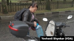 Melania, 28, drives around town looking for water and says she tries not to worry about the threat of a nuclear disaster in Nikopol, Ukraine.