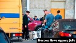 Investigators work at the site of the place where the downed Ukrainian drone fell in Krasnogorsk, just outside Moscow, Russia, Aug. 22, 2023. 