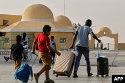 Passengers fleeing war-torn Sudan cross into Egypt through the Argeen Land Port on May 12, 2023.