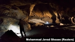 A person stands in Pebdeh Cave, in the Zagros Mountains, Iran, in this undated photo obtained by Reuters on March 25, 2024. Pebdeh Cave was occupied by hunter-gatherers as early as 42,000 years ago, inferred to be Homo Sapiens. (Mohammad Javad Shoaee/Handout via REUTERS)