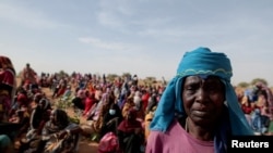 Halime Adam Moussa, a Sudanese refugee, waits with other refugees to receive a food portion from World Food Program in Koufroun, Chad, near the border between Sudan and Chad, May 9, 2023. 