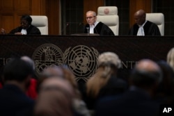 Presiding Judge Nawaf Salam reads the ruling of the International Court of Justice, or World Court, in The Hague, Netherlands, May 24, 2024.