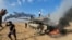 FILE — Palestinians celebrate by a destroyed Israeli tank at the Gaza Strip fence, Oct. 7, 2023. As images of the Israel-Hamas war circulated around the world, people in Rome commemorated the Nazi roundup of Rome&#39;s Jewish community during World War II.