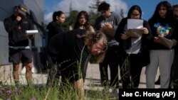 Associate professor Vered Mirmovitch, front, leads students on a plant tour on the West Los Angeles College campus, March 12, 2024. As students consider jobs that play a role in solving the climate crisis, community colleges are responding. (AP Photo/Jae C. Hong