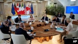 Summit host, Italian Prime Minister Georgia Meloni, top center, addresses fellow G7 leaders during a roundtable session on the first day of their summit, at Borgo Egnazia, southern Italy, June 13, 2024.