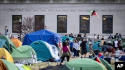 A student protester flies a kite inside the protest encampment on the Columbia University campus, April 29, 2024, in New York. 