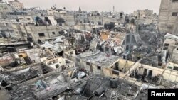 People search through the rubble of damaged buildings following an Israeli air strike on Palestinian houses, in Rafah, southern Gaza Strip, Dec. 12, 2023. 