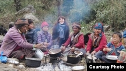 French journalist Vanessa Dougnac, center, sits with nomads in Nepal, 2021. Married to an Indian, Dougnac lived in India for more than two decades before being forced to leave in February 2024 after Indian authorities accused her of writing "malicious" reports.