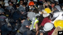 Police advance on pro-Palestinian demonstrators on the UCLA campus, in Los Angeles, May 2, 2024.