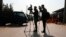 FILE - Afghan journalists film in Kabul, Afghanistan, Feb. 9, 2021.