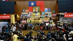 FILE - In this April 7, 2014 photo, students occupy the Parliament floor to protest against a trade pact with China in Taipei, Taiwan. Many activists from the "Sunflower Movement" are now running for elected office to help bring about change. 